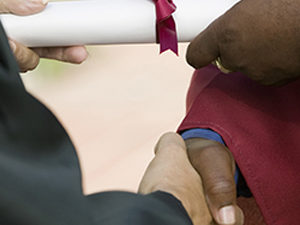 Graduate Receiving Diploma and Handshake