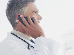 Attractive doctor phoning