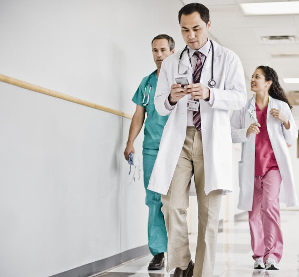 Doctor Using Cell Phone in Hallway