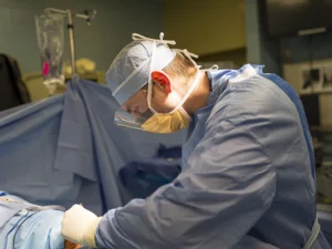 Orthopedic surgeon performs surgery in an operating room