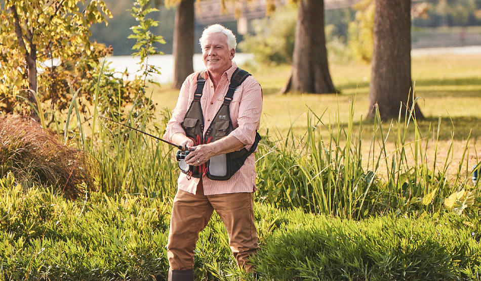 Older gastroenterologist physician fishing outdoors