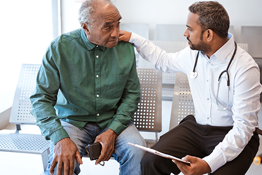 Physician talking to an older man