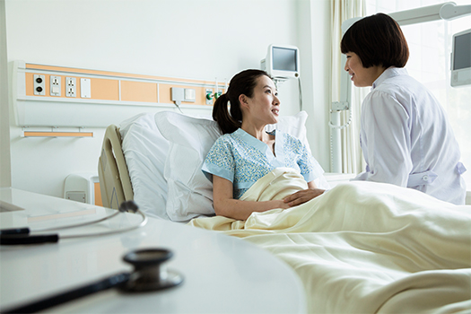 physician showing concern for patient in hospital bed