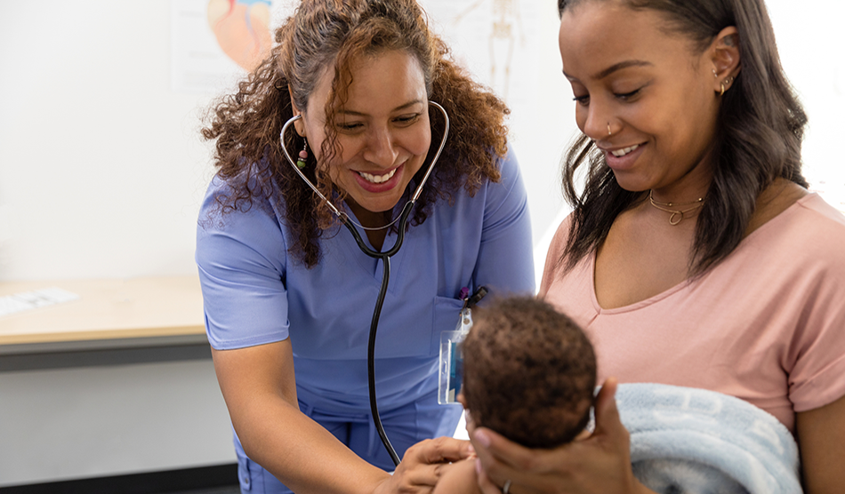 Nurse practitioner talks to a patient and her infant during an appointment