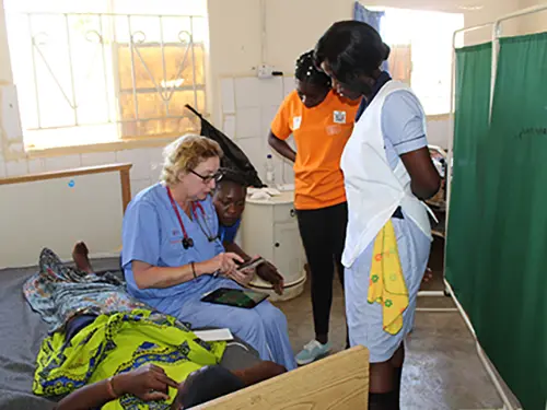 Dr. Linda Holt treating a patient in Zambia