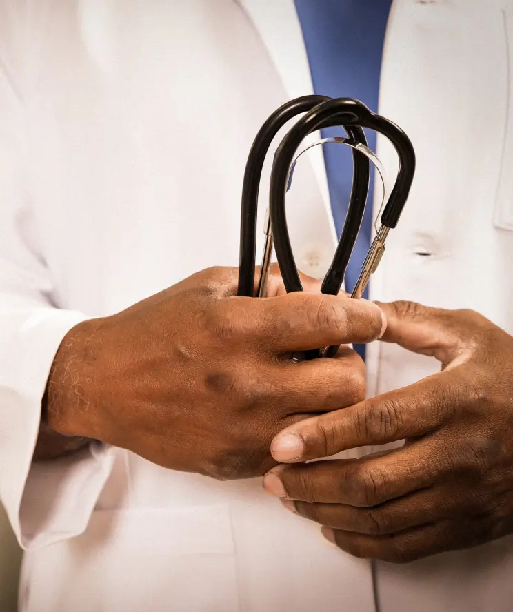 A locums physician holds a stethoscope